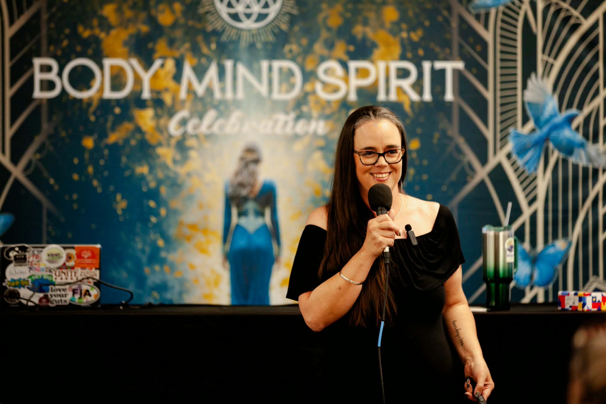 Woman speaking into microphone at event with